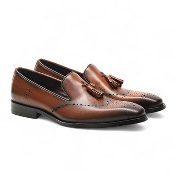 Front view of handmade brown tassel loafers with burnished toe finish