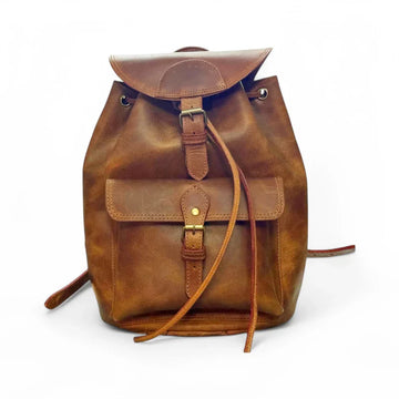Expertly crafted from genuine leather, this handmade backpack is perfect for college students. The backpack features a front pocket for easy access to essentials, making it a practical and stylish choice for everyday use. Stay organized and look sophisticated with the Country Leather Backpack.