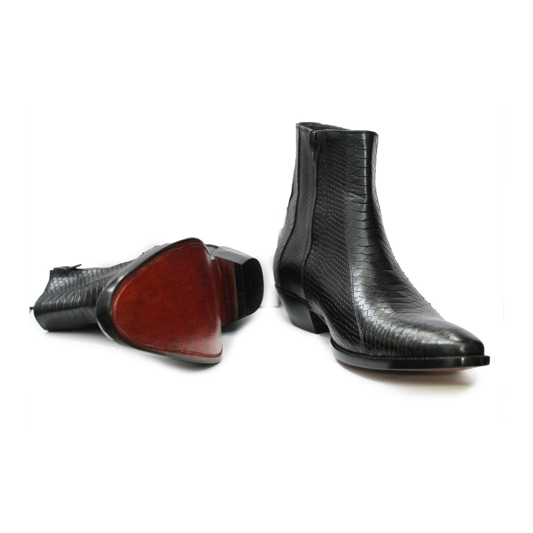 Black leather ankle boots with a glossy finish on a white background