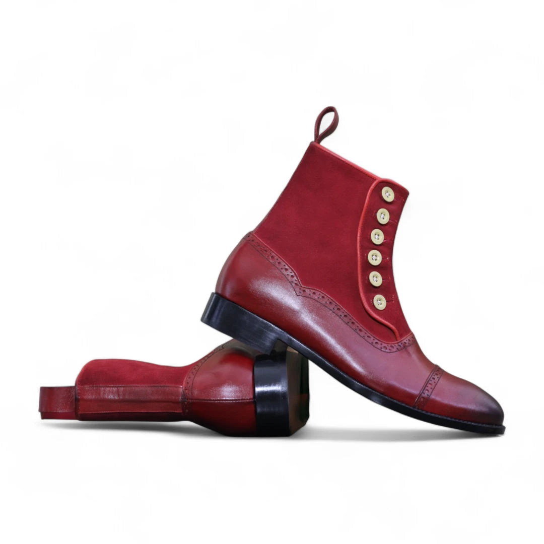 Red leather boot with gold buttons on a white background