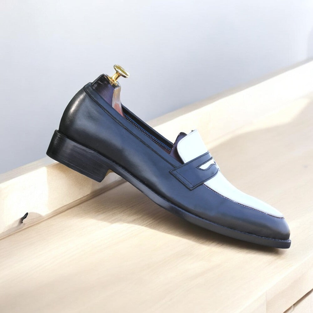 Black and white leather penny loafers on white background from Posh Footwears