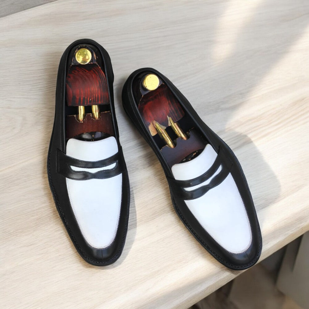 Black and white leather penny loafers on white background from Posh Footwears