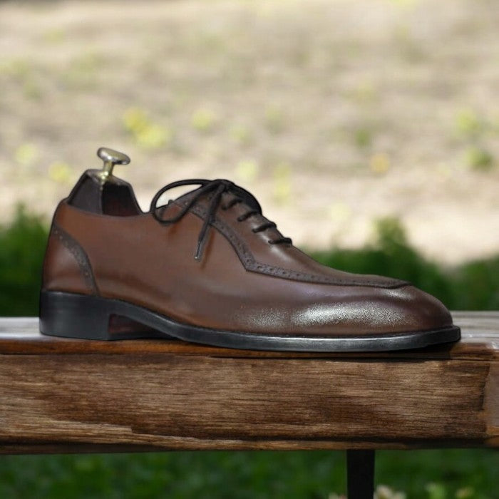 Men's lace-up oxford brown leather dress shoes on a white background