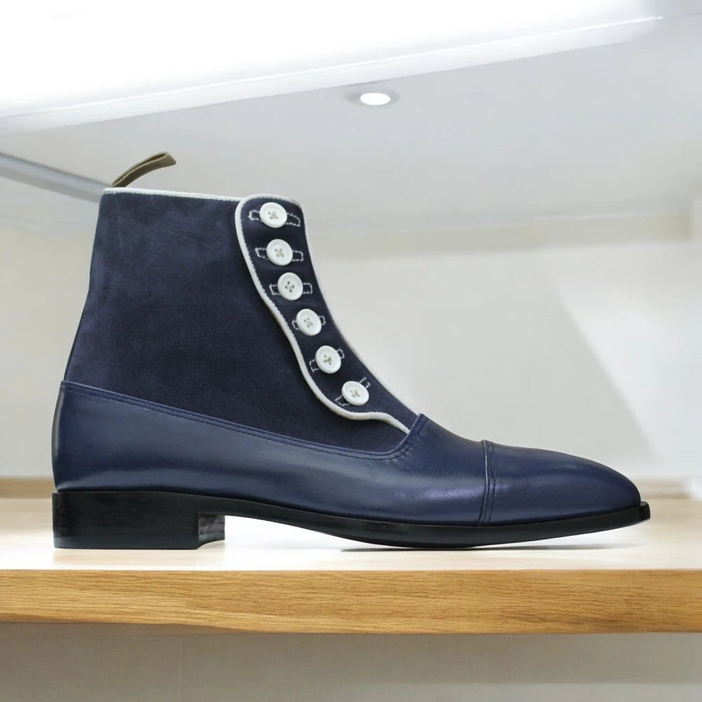 Navy Handmade Leather Button Boots displayed on a wooden surface, highlighting their elegant design and quality craftsmanship.