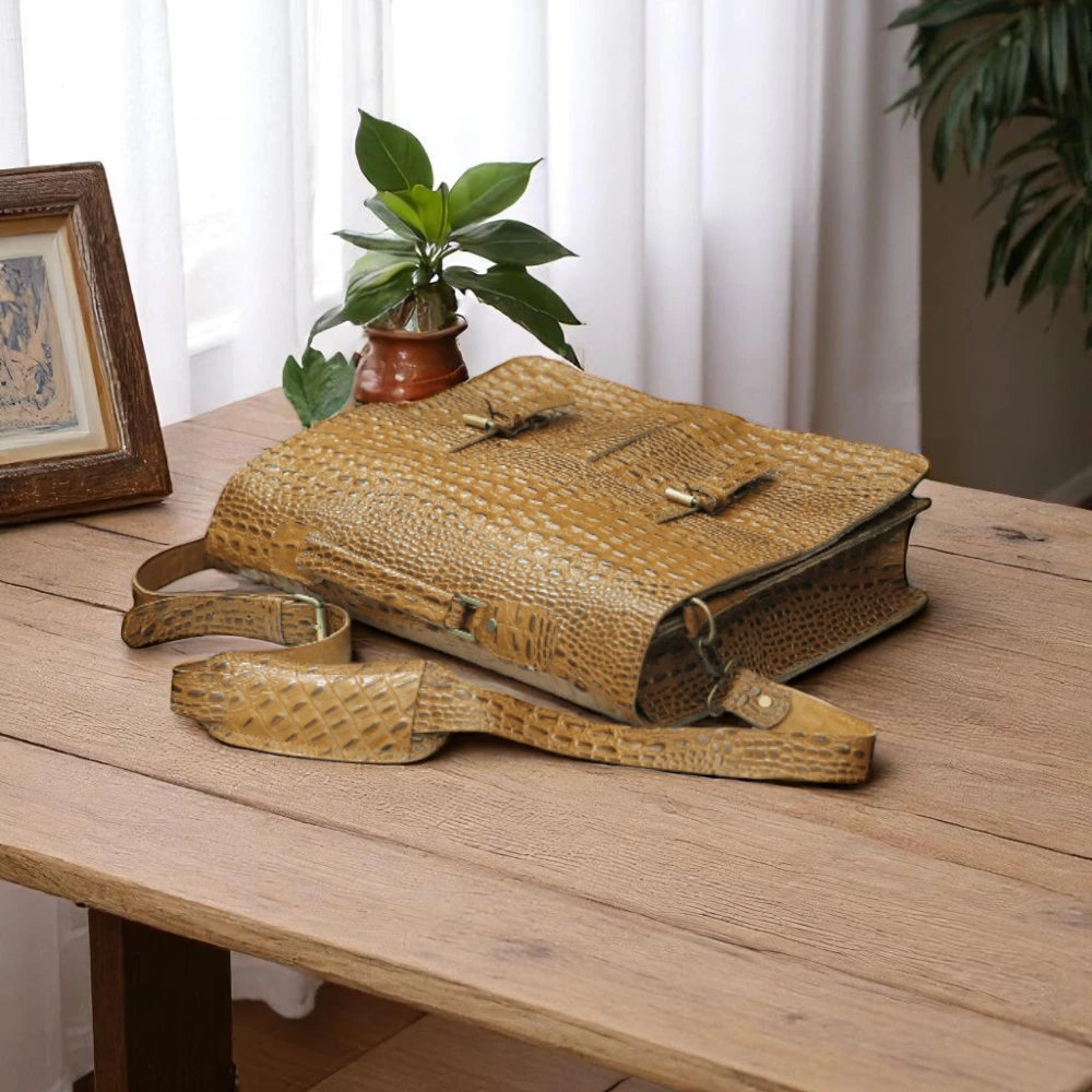 Expertly crafted with genuine alligator print leather, this handmade tan bag is perfect for the office or daily use. Its spacious design can accommodate a laptop, making it the ideal choice for tech-savvy professionals. A sophisticated and stylish choice for men, this bag is sure to elevate any outfit.