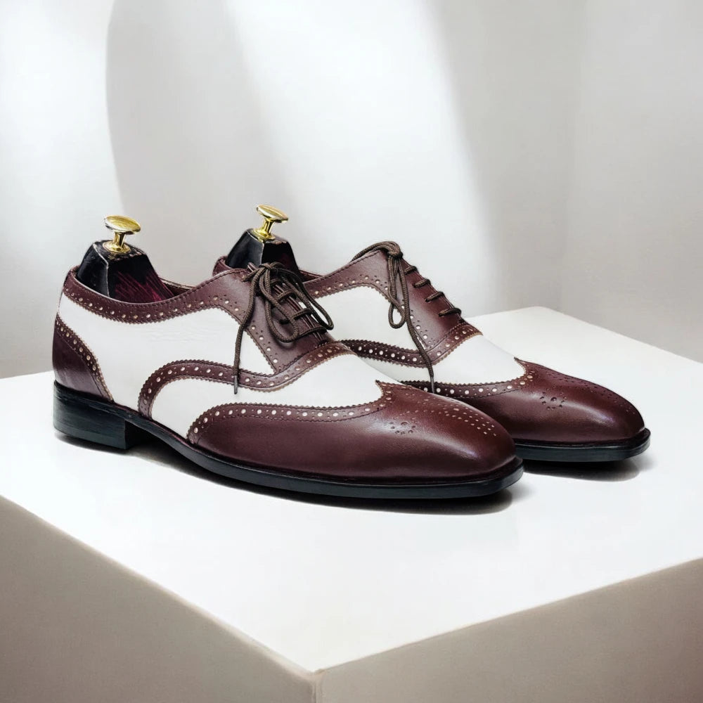Handmade two-tone leather wingtip Oxfords in brown and white, with leather sole and available in USA sizes 5-15