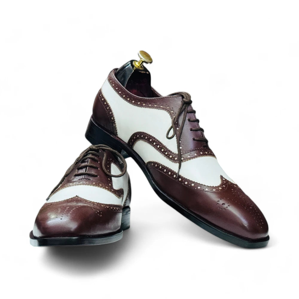Handmade two-tone leather wingtip Oxfords in brown and white, with leather sole and available in USA sizes 5-15