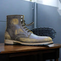 Men's vintage brown ankle boots made from genuine leather, showcasing a distressed finish and a classic design for a stylish, rugged look.