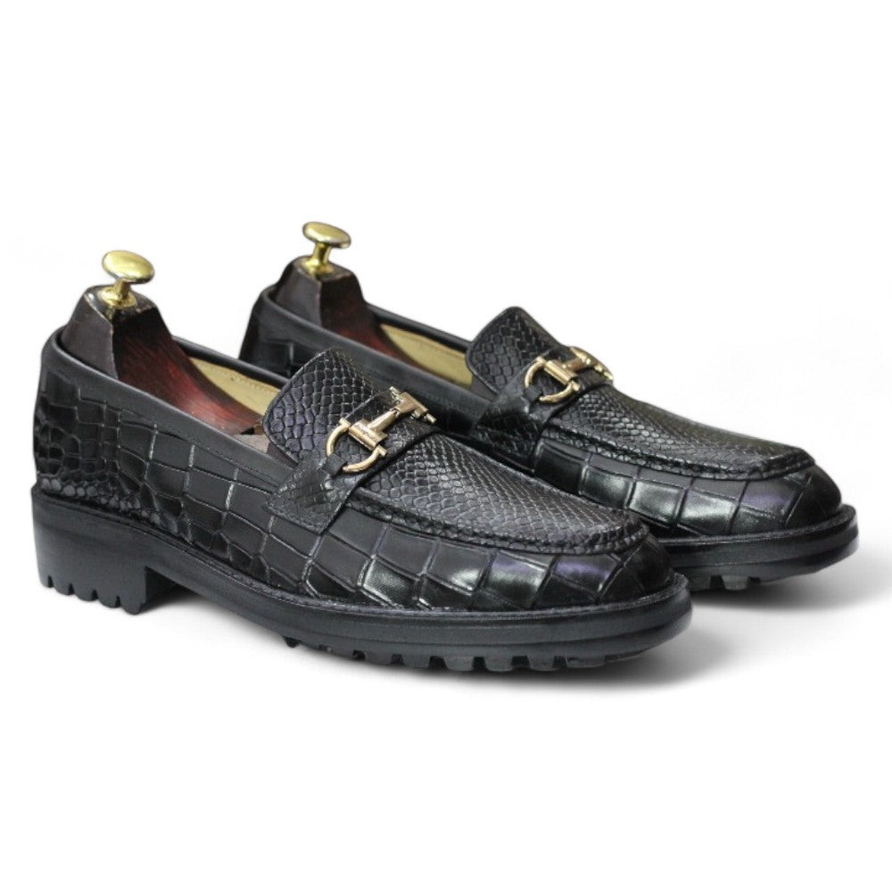 Black Alligator Loafer Shoes displayed on a wooden surface, showcasing their sleek design and elegant texture.