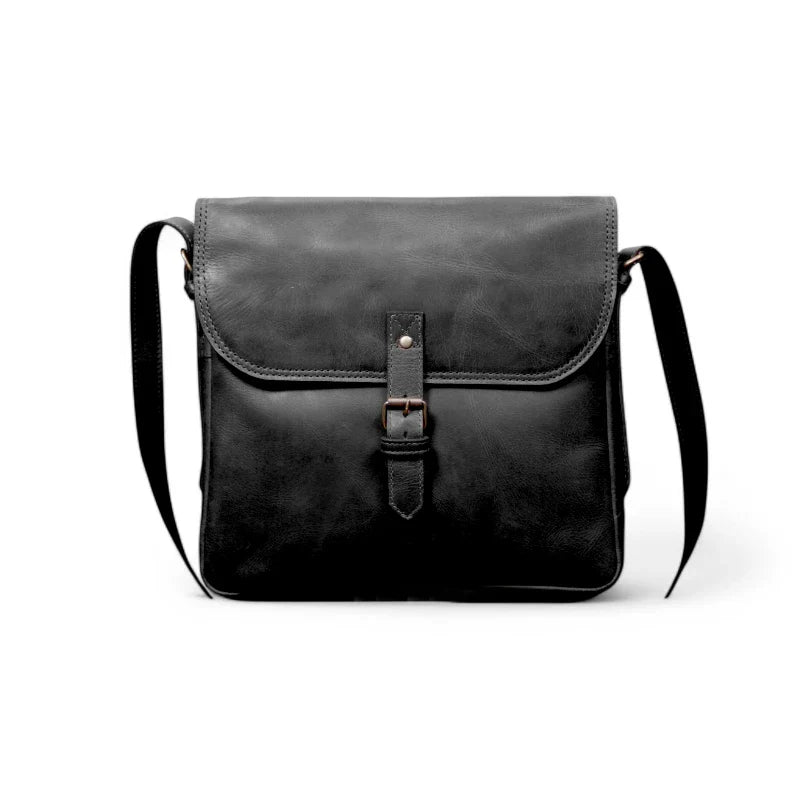 6️⃣ Leather satchel displayed with everyday essentials – Perfectly fits an iPad, phone, wallet, and notebook.
