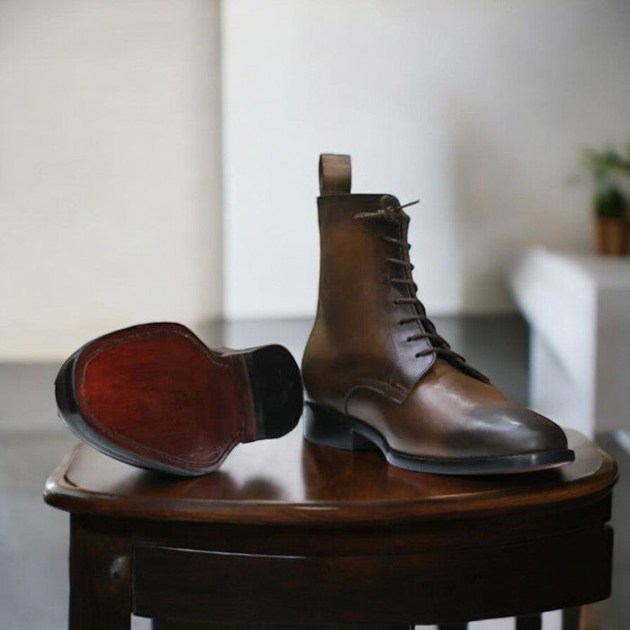 Handmade men's brown leather ankle boots with a cap toe and lace-up design, featuring premium leather and a durable sole, perfect for casual and semi-formal wear.