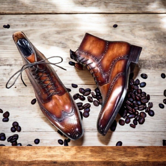 Handmade men's brown patina wingtip brogue dress boots with detailed perforations, lace-up closure, and a polished leather finish, perfect for formal or casual wear
