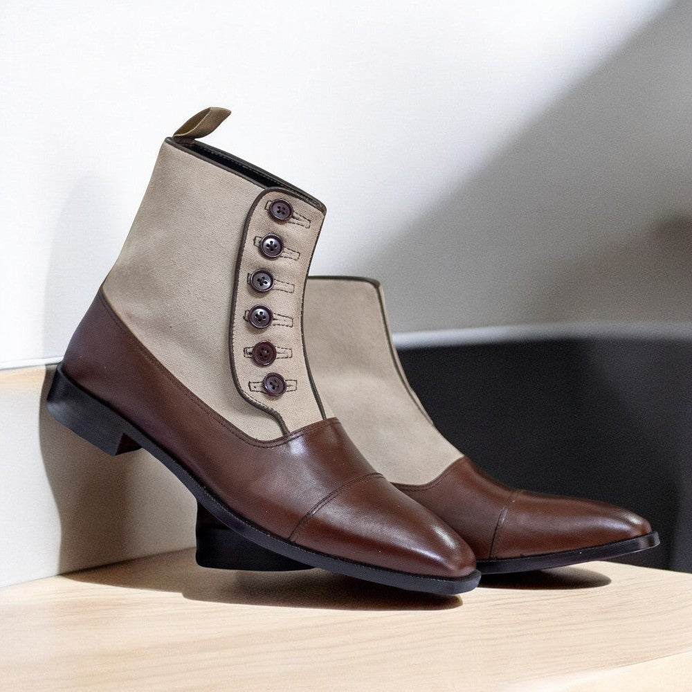 Men's Leather Suede Button Boots displayed on a wooden surface, showcasing their elegant design and craftsmanship.