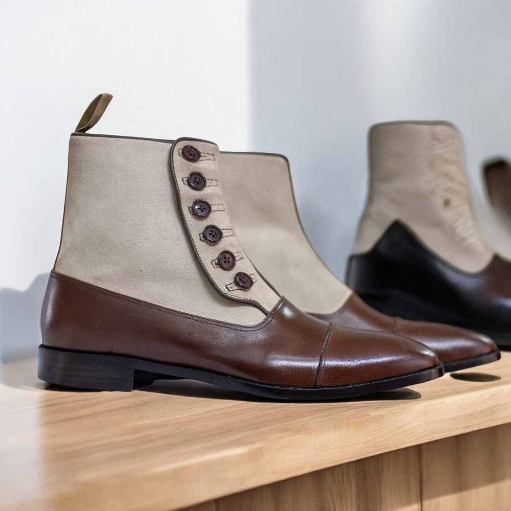 Men's Leather Suede Button Boots displayed on a wooden surface, showcasing their elegant design and craftsmanship.