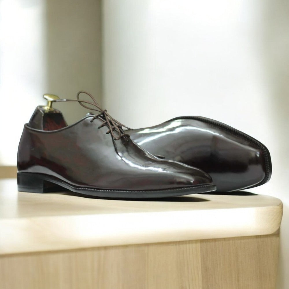 Men's brown patent leather single monk shoes with a sleek design, featuring a glossy leather upper, single buckle strap, and a durable leather sole, ideal for formal occasions