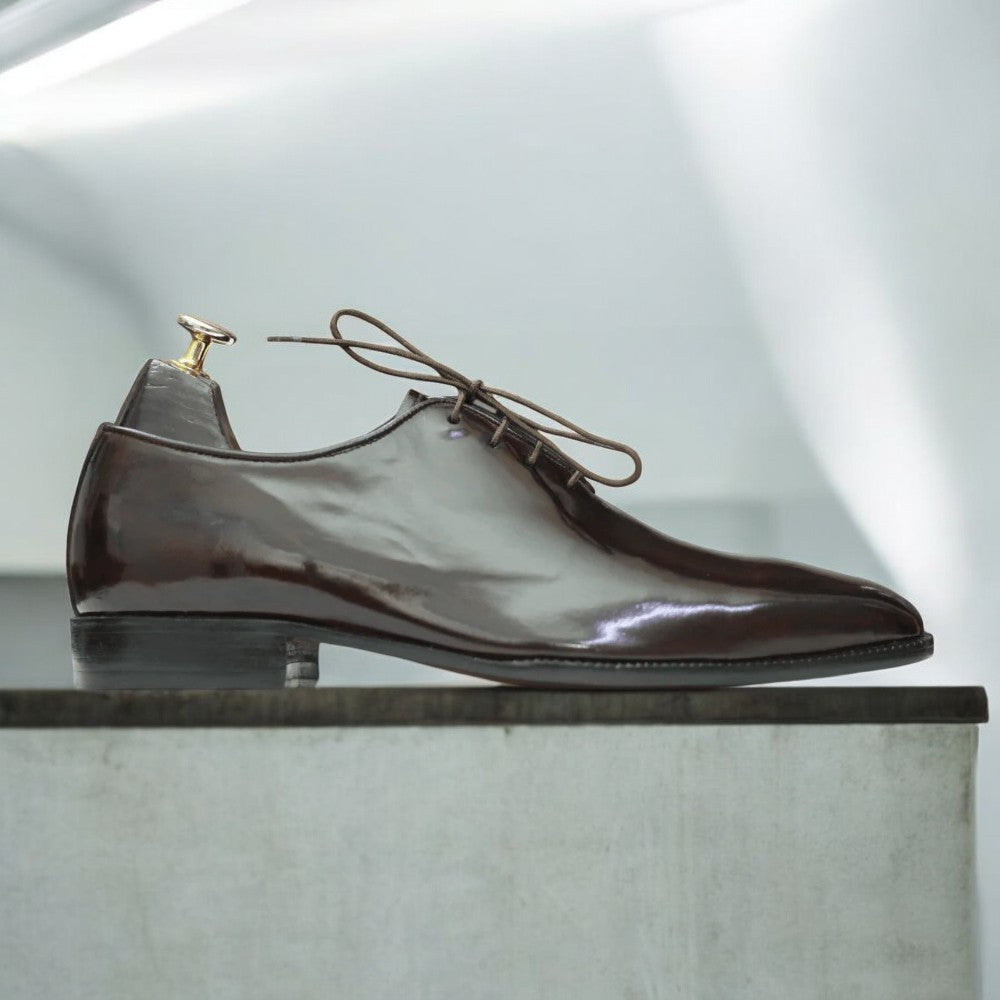 Men's brown patent leather single monk shoes with a sleek design, featuring a glossy leather upper, single buckle strap, and a durable leather sole, ideal for formal occasions