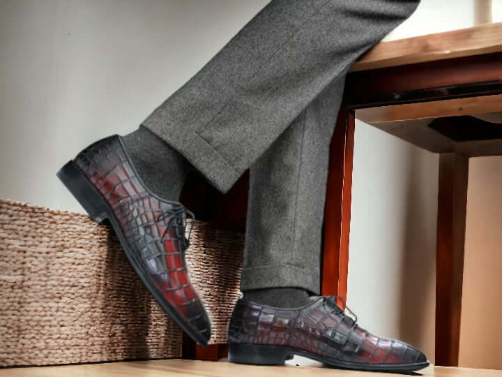 Pair of brown and black leather dress shoes on a white background