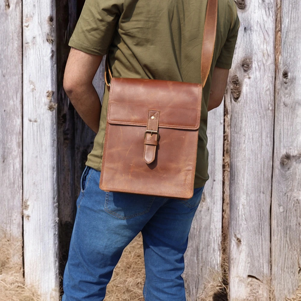 Adjustable shoulder strap with reinforced leather ends

