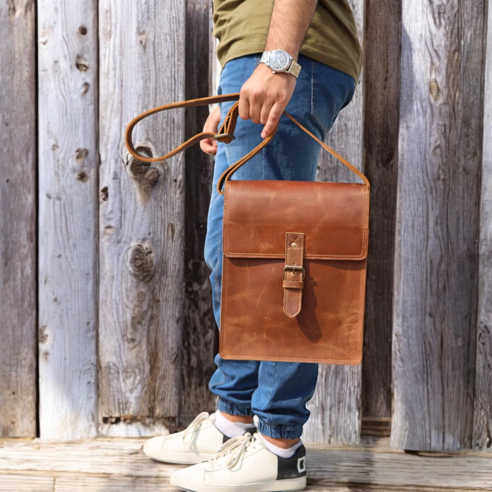 Adjustable shoulder strap with reinforced leather ends

