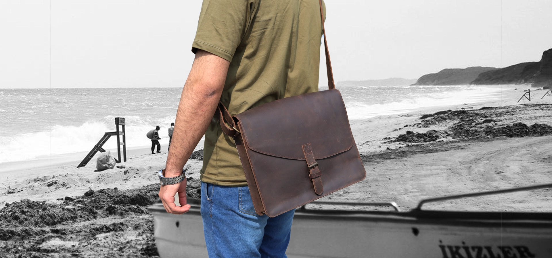 Person holding a brown leather briefcase with a blurred background1621243260e1af0c20-1
