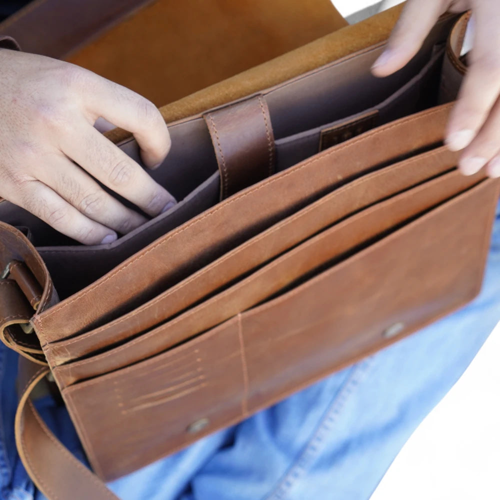 Pocket Detail View – Zoomed-in shot of the leather phone sleeve and inner accessory compartments.

