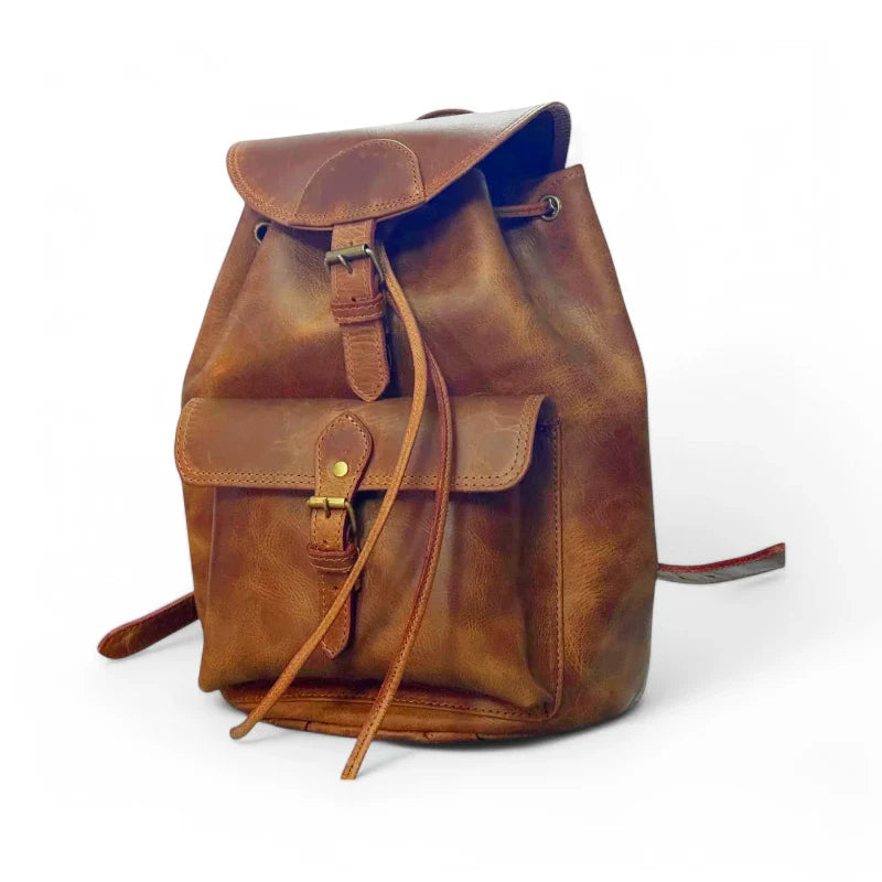 Expertly crafted from genuine leather, this handmade backpack is perfect for college students. The backpack features a front pocket for easy access to essentials, making it a practical and stylish choice for everyday use. Stay organized and look sophisticated with the Country Leather Backpack.