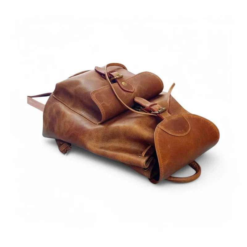 Expertly crafted from genuine leather, this handmade backpack is perfect for college students. The backpack features a front pocket for easy access to essentials, making it a practical and stylish choice for everyday use. Stay organized and look sophisticated with the Country Leather Backpack.