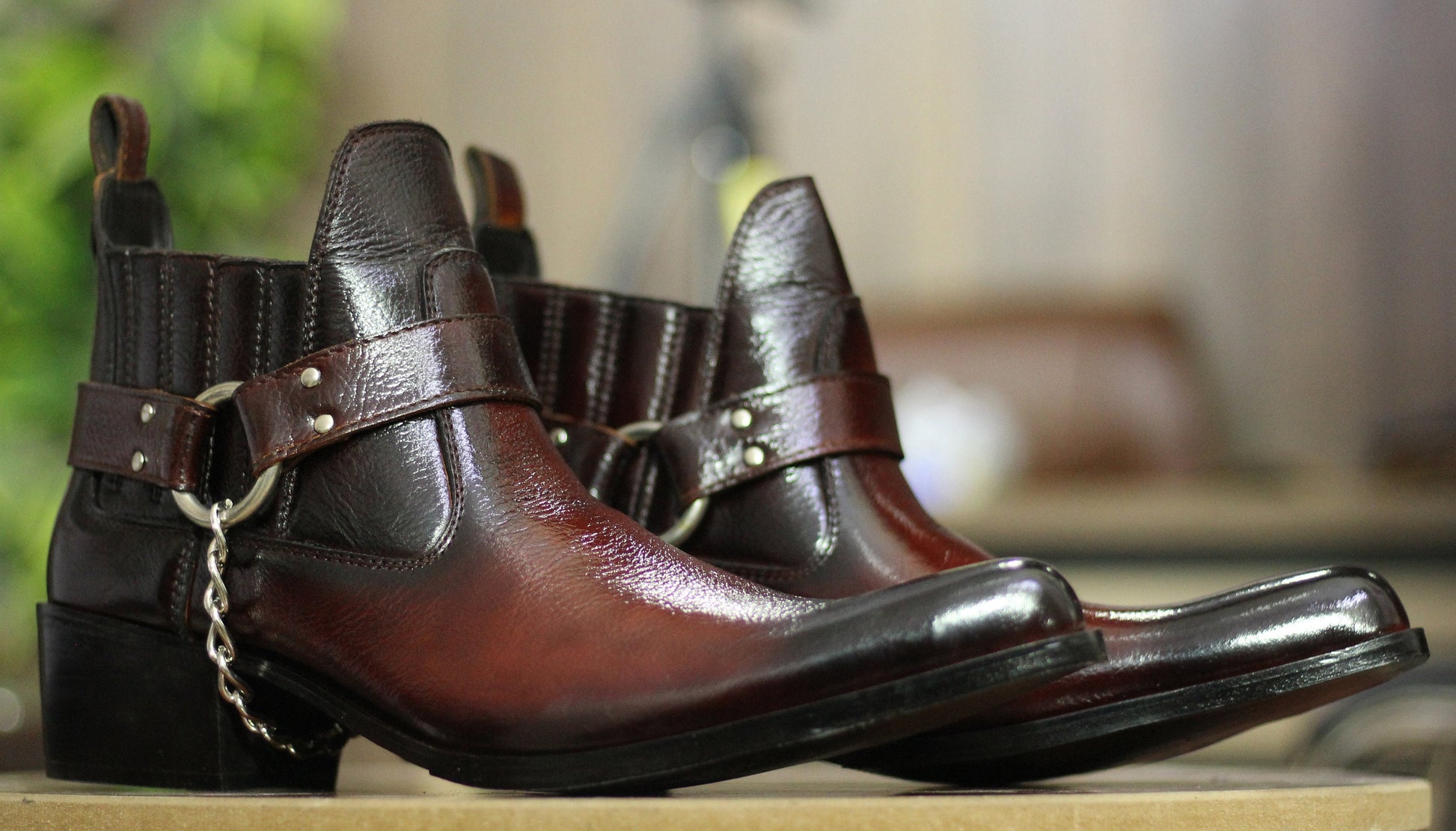 Front View – Rugged full-grain leather harness boots with bold buckle detail and round toe design.

