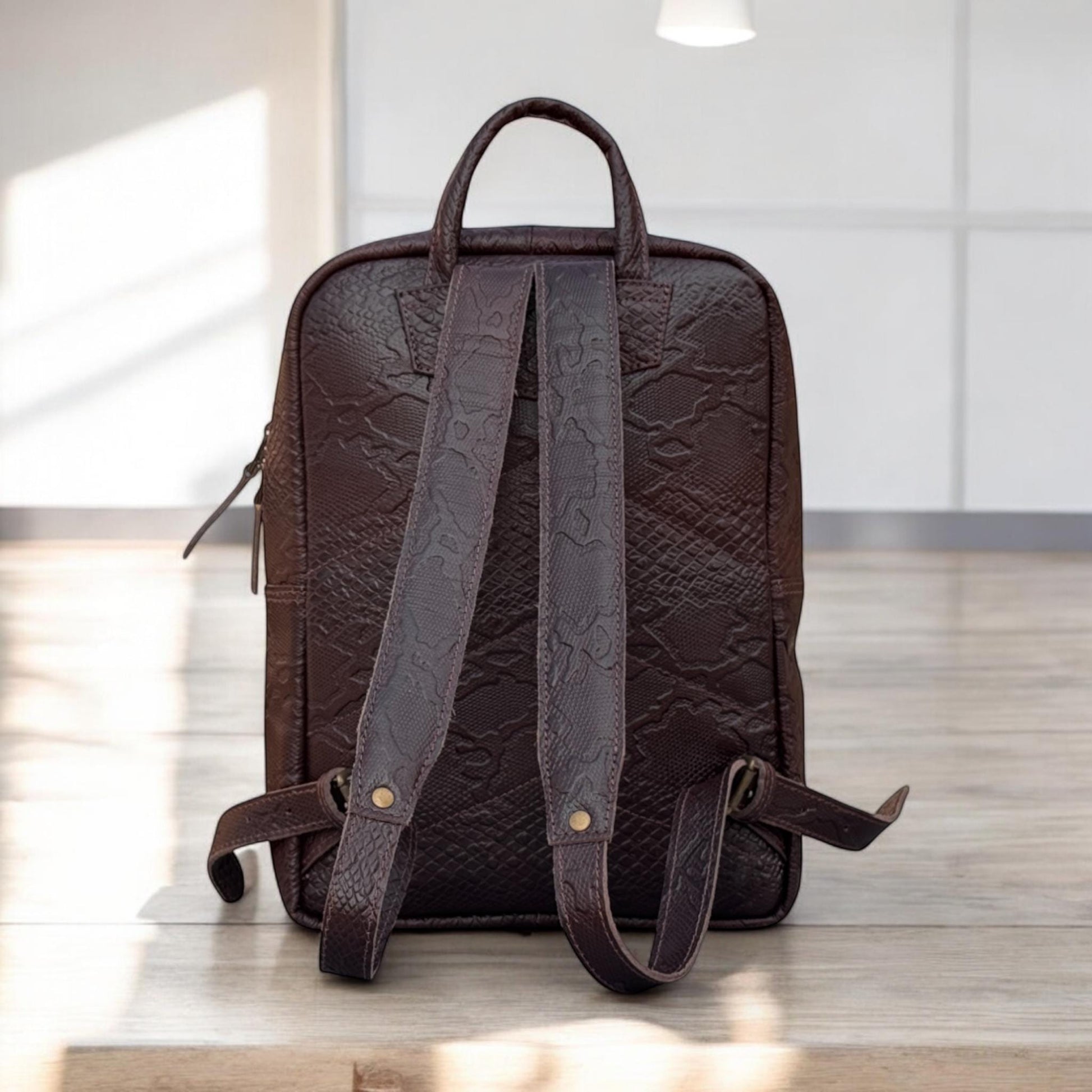 Back View – Rear view showing adjustable leather shoulder straps and hidden security pocket.


