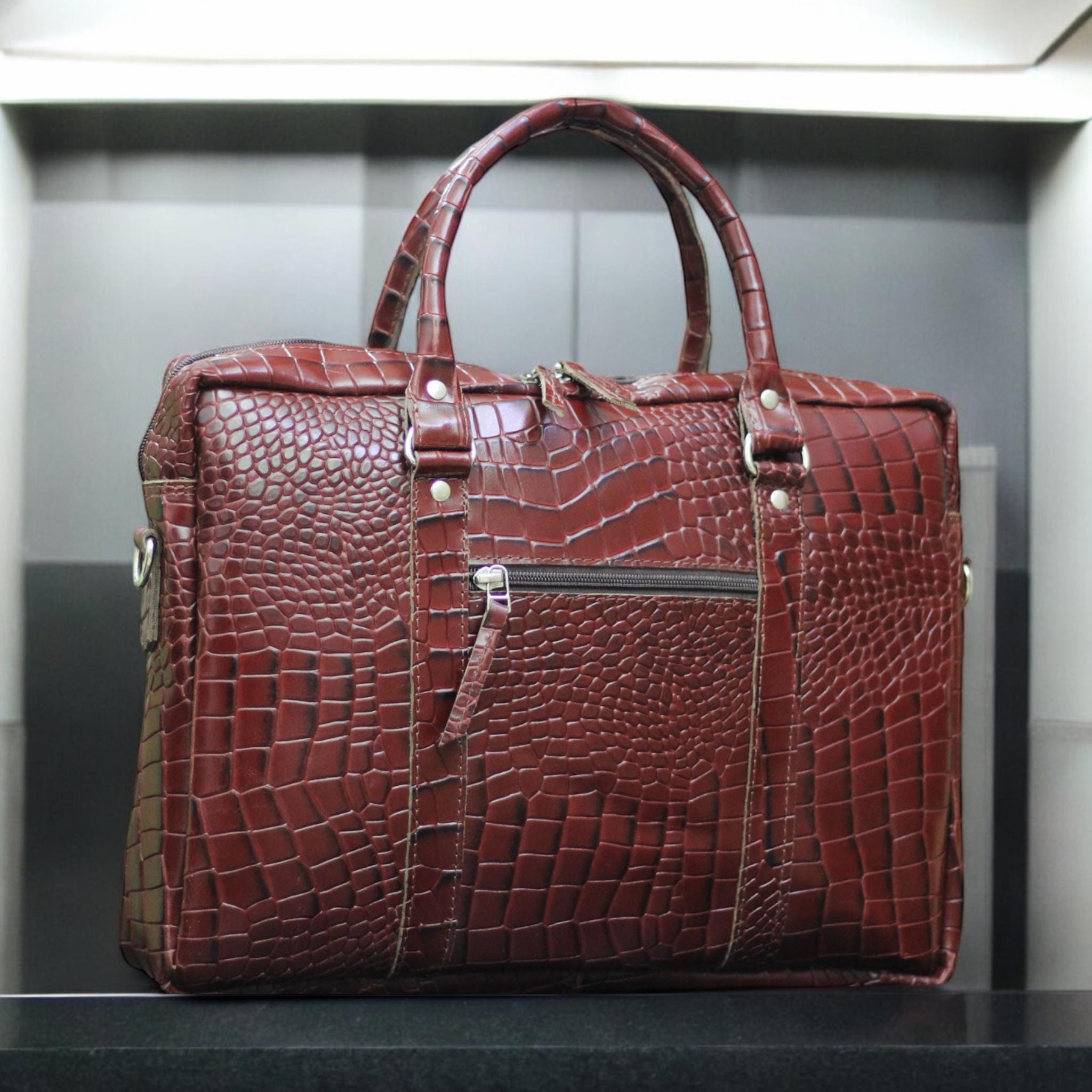 Front View – Elegant alligator-textured leather laptop bag with flap closure and sleek silhouette.

