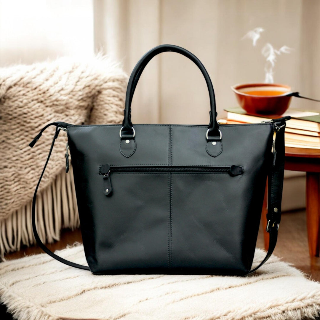 Front View – Classic leather tote bag in tan with clean lines and personalized initials on front.

