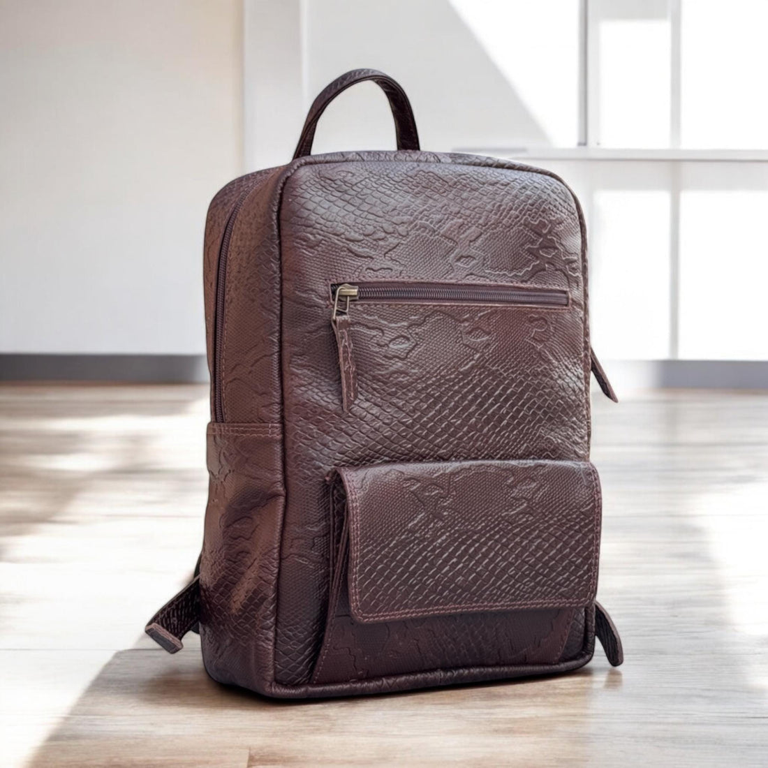 Brown textured backpack on a white background