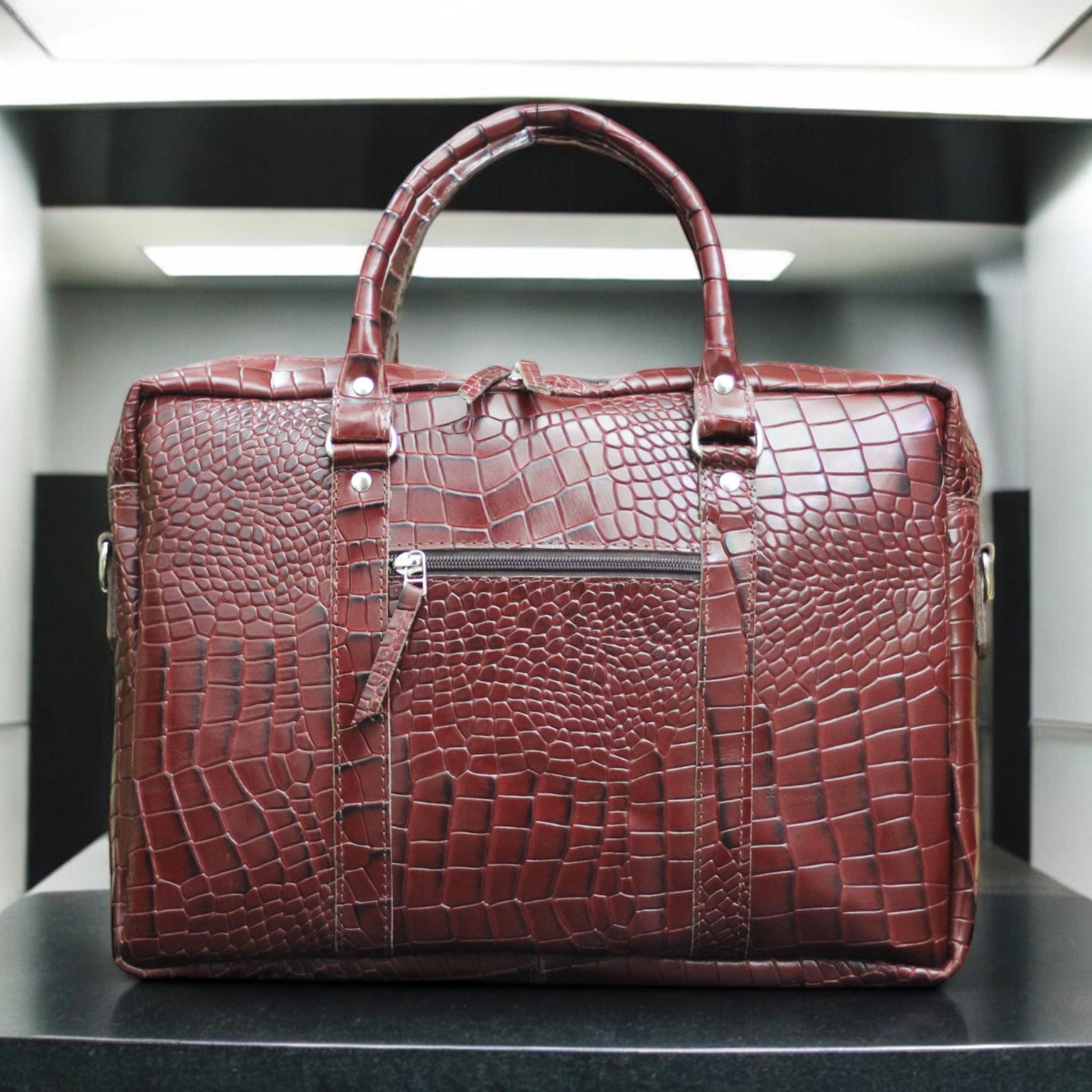 Front View – Elegant alligator-textured leather laptop bag with flap closure and sleek silhouette.

