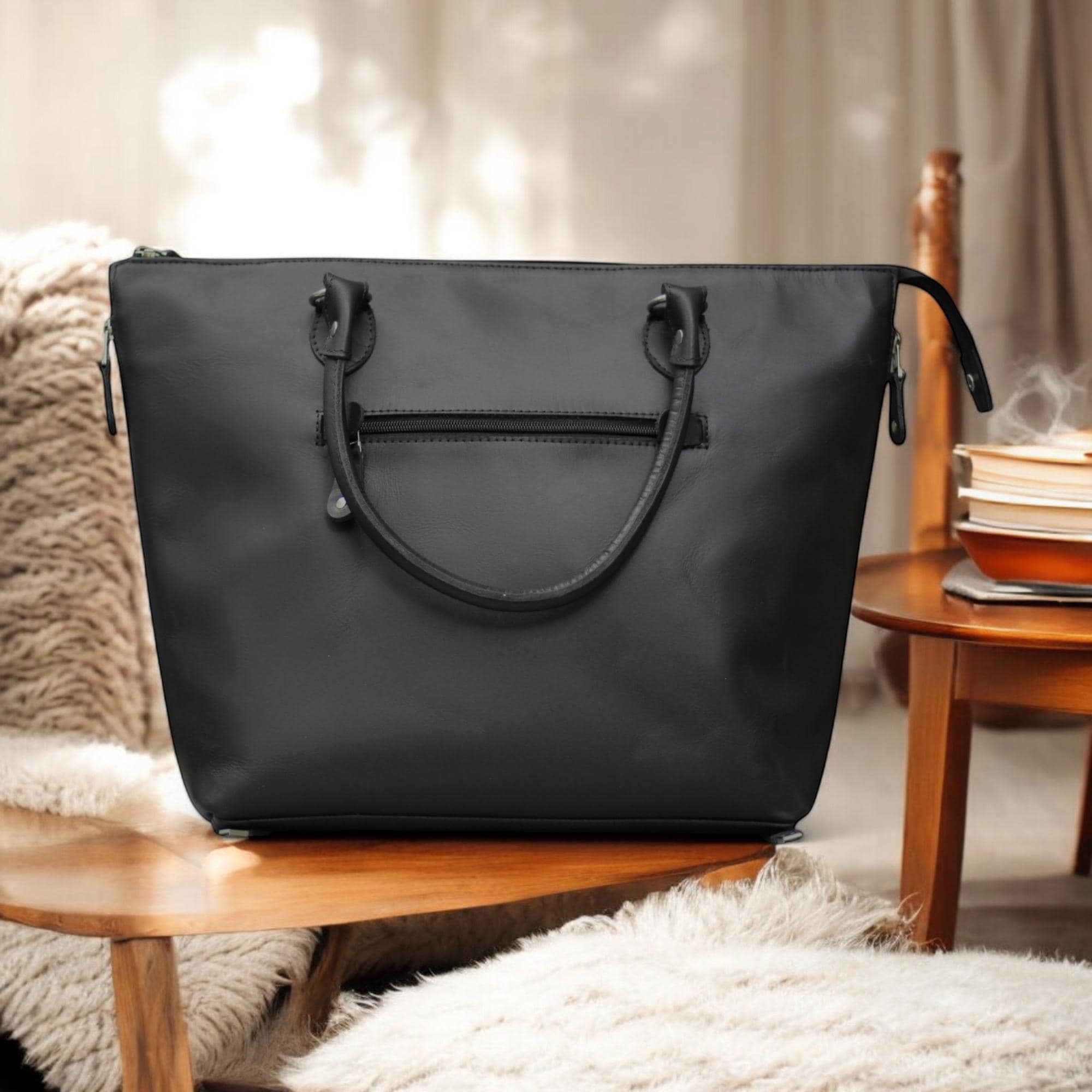 Front View – Classic leather tote bag in tan with clean lines and personalized initials on front.

