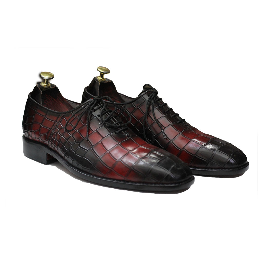 Pair of brown and black leather dress shoes on a white background